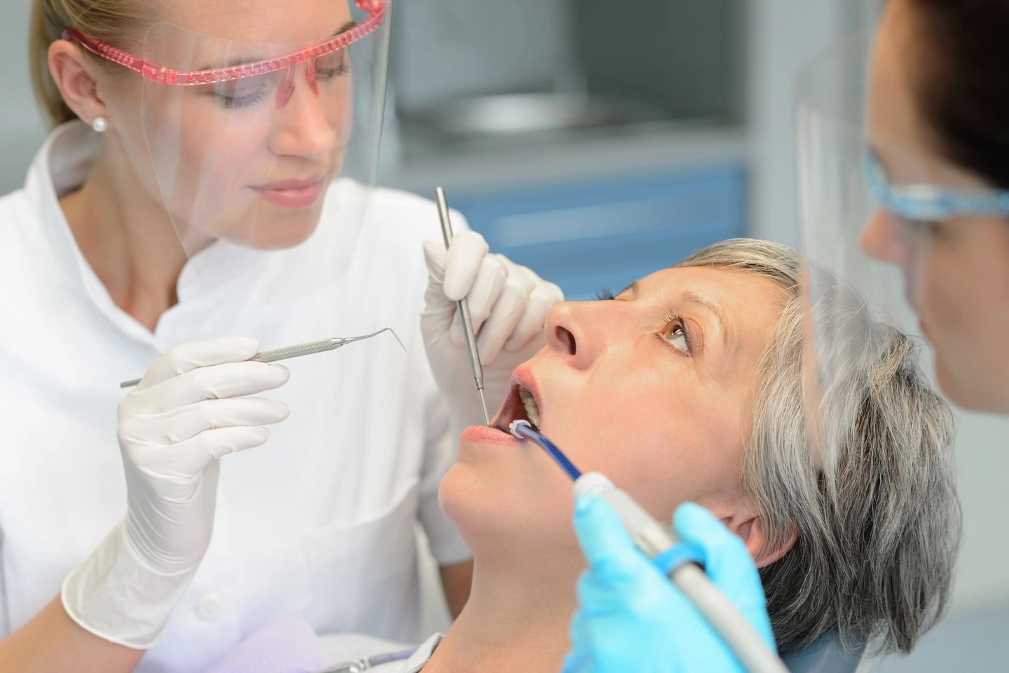 dentist winter park checks patient's teeth