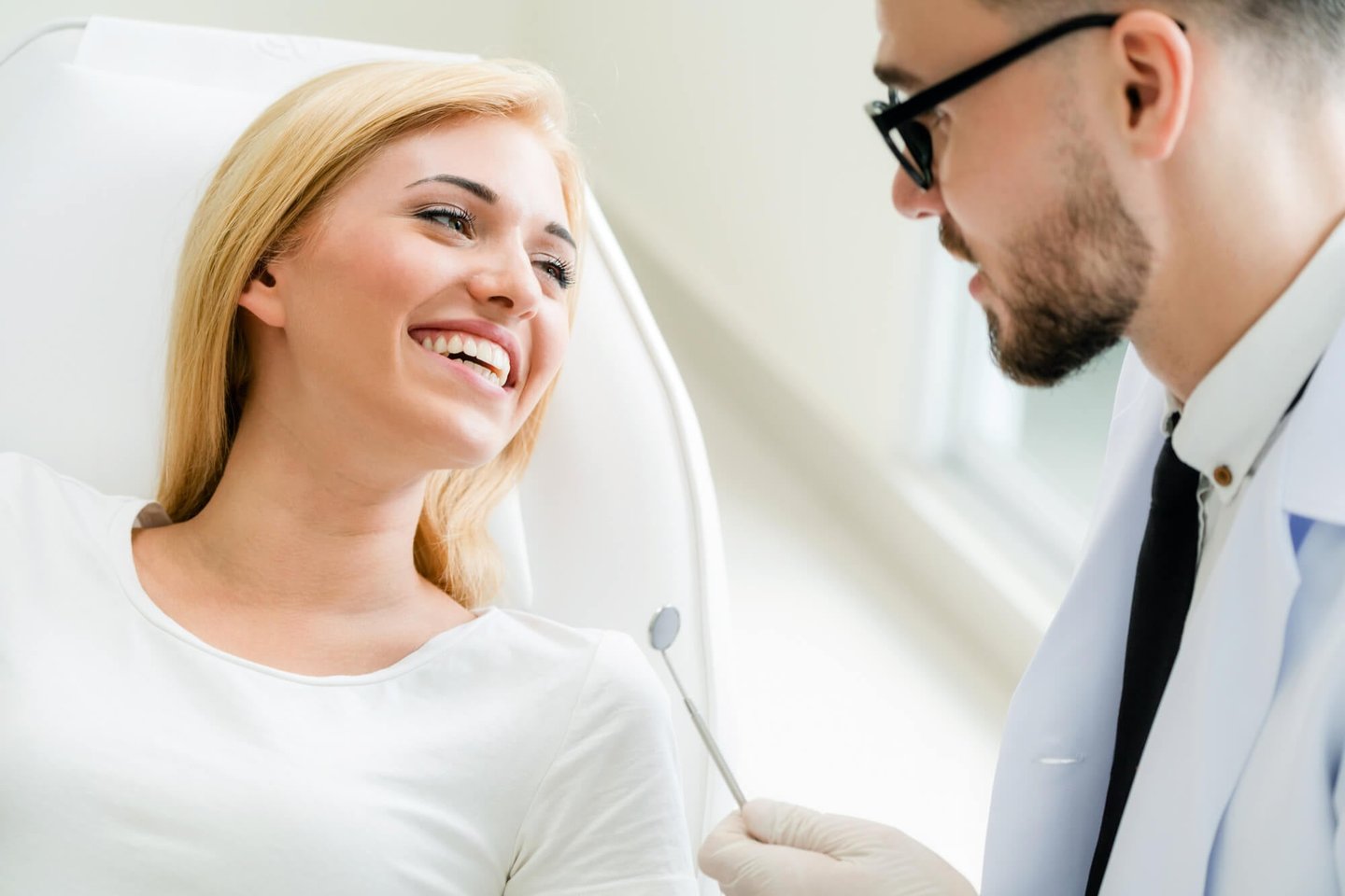 blonde patient smiling at cosmetic dentist winter park