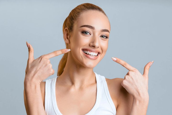 Woman showing her veneers winter park