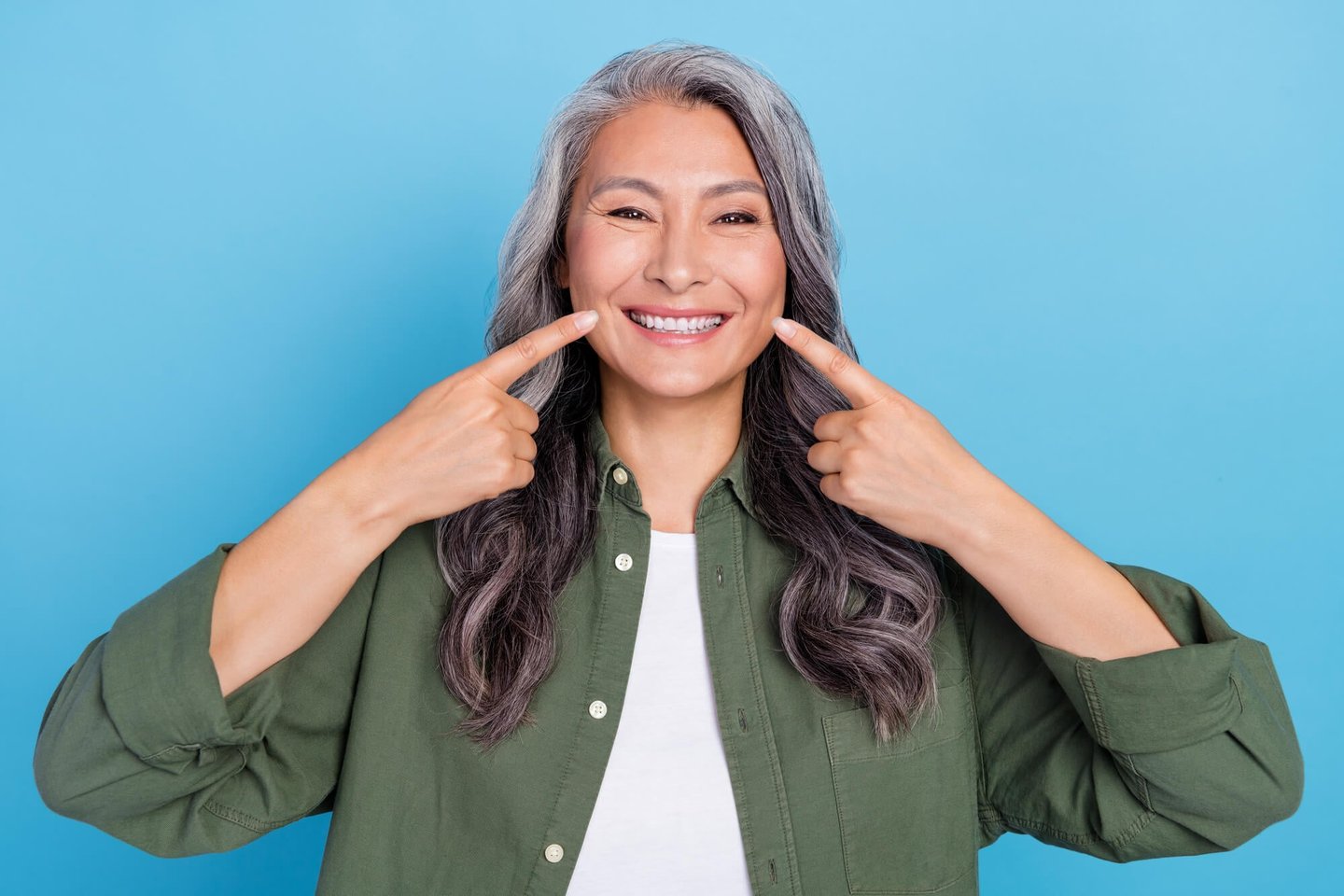 Asian woman smiling wearing the best veneers in orlando