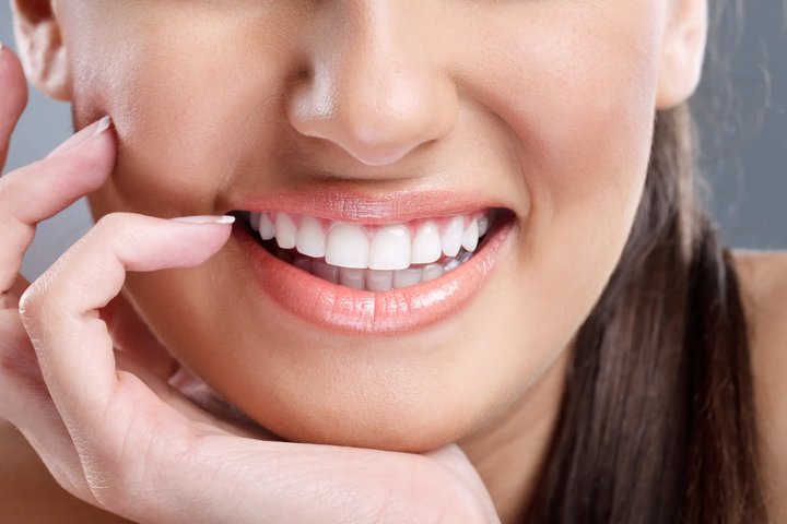 woman smiles after a full mouth restoration