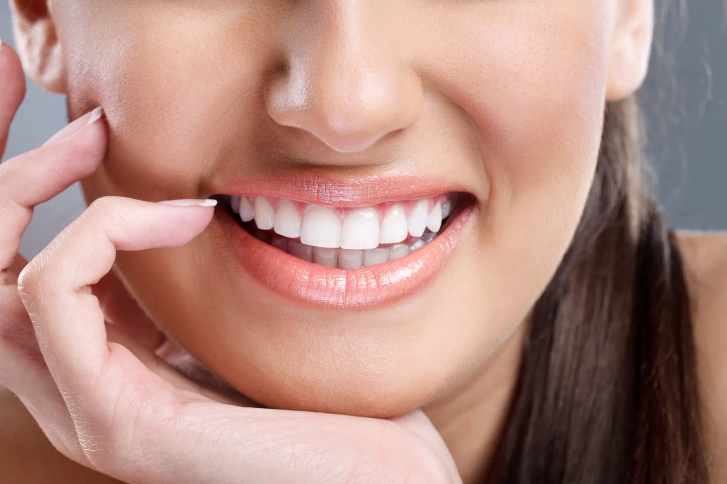 woman smiles after a full mouth restoration