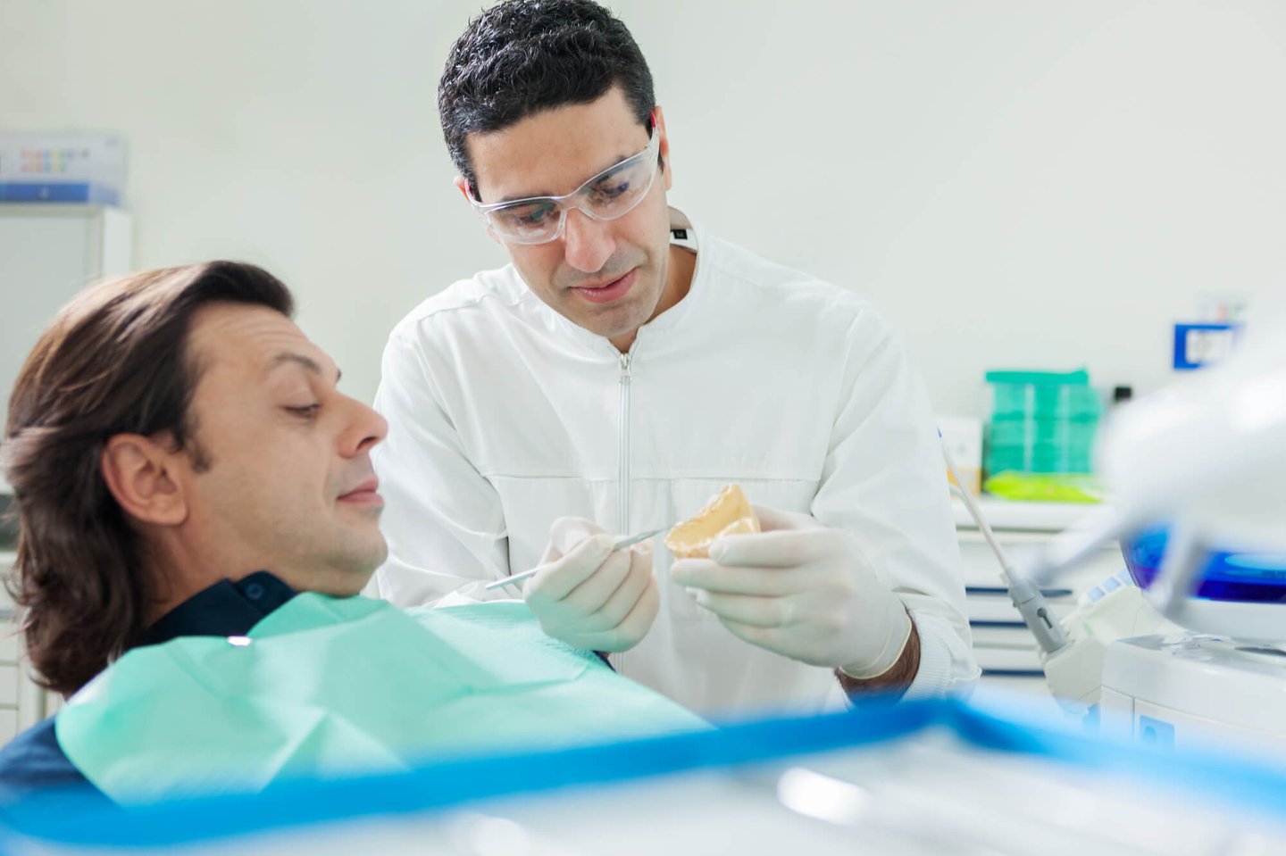 dentist showing Dental Implants to patient