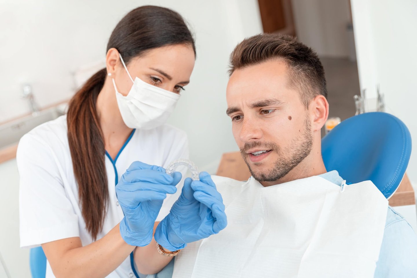 dentist showing patient his new invisalign winter park