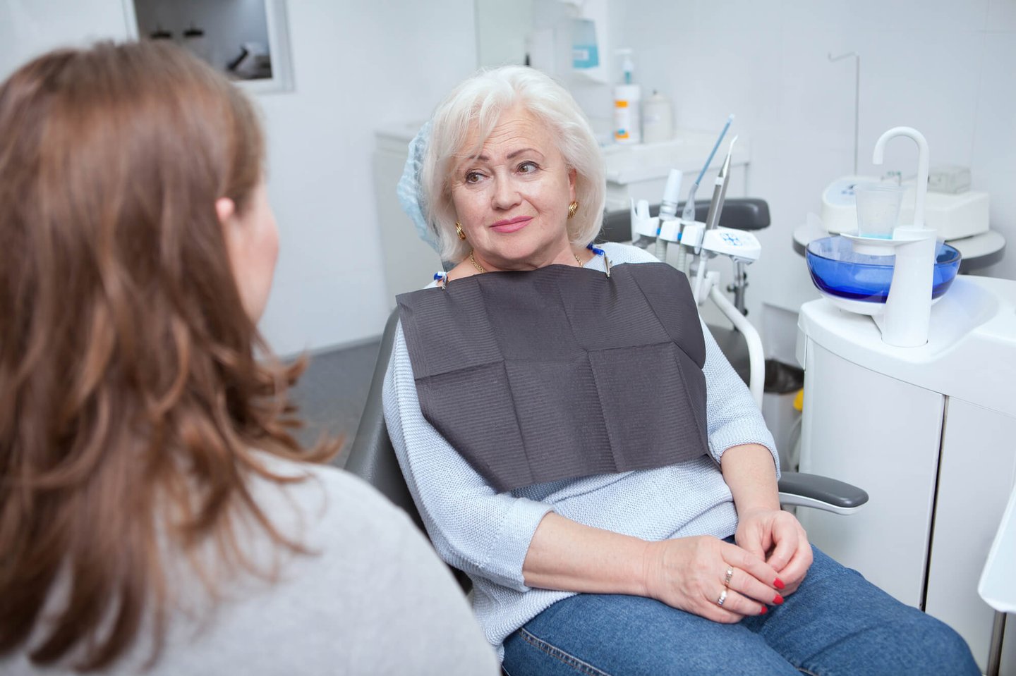 dentist explaining the dental implants winter park fl process to patient