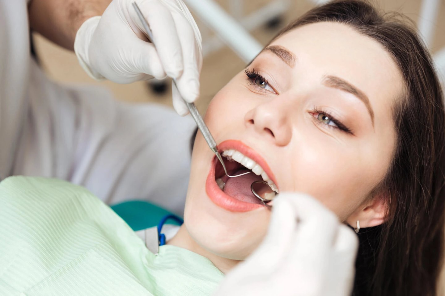 Girl-undergoing-follow-up-check-up-of-her-porcelain-veneers-orlando-fl