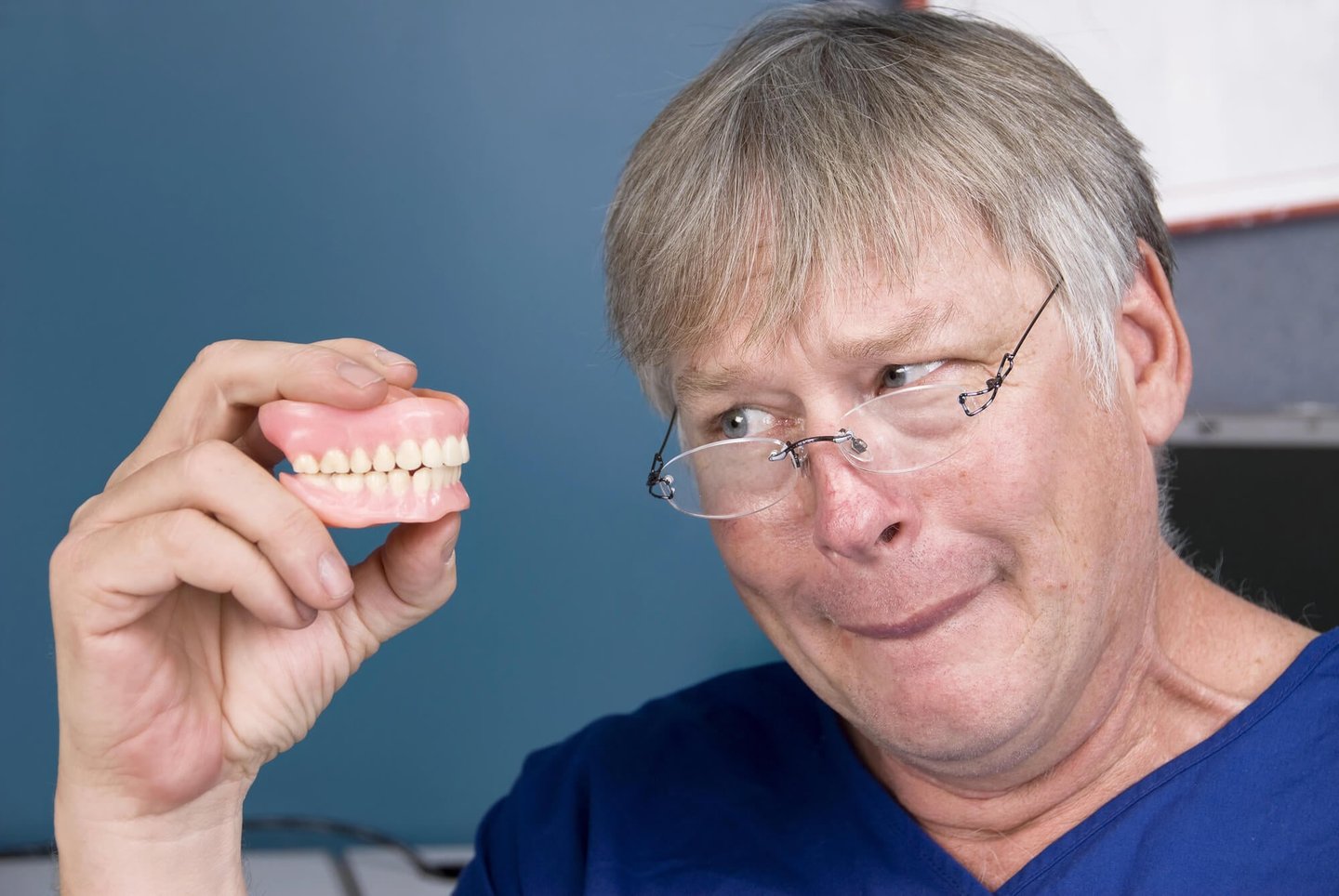 dentists in winter park fl holding a denture model