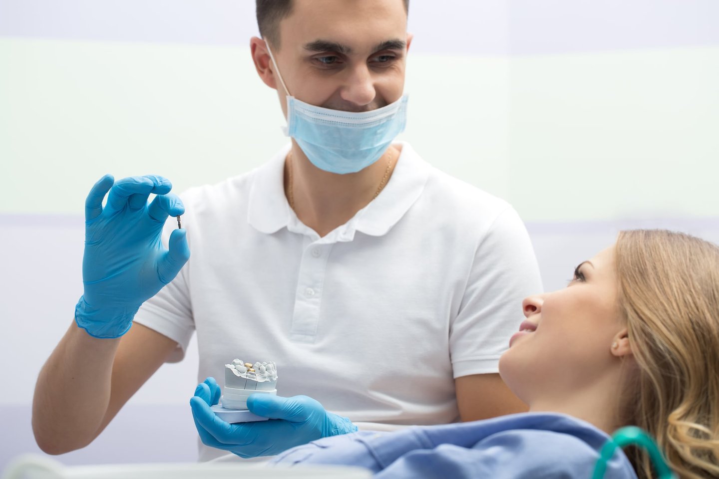 Dentist showing Dental Implants to patient