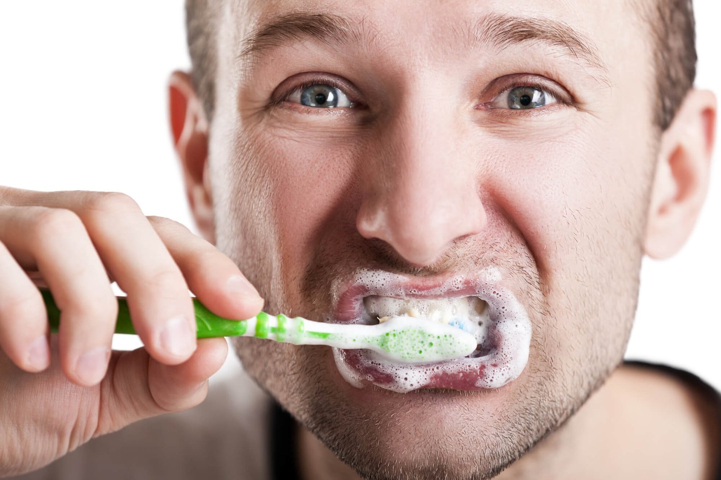 man brushes teeth as suggested by a dentist in Winter Park