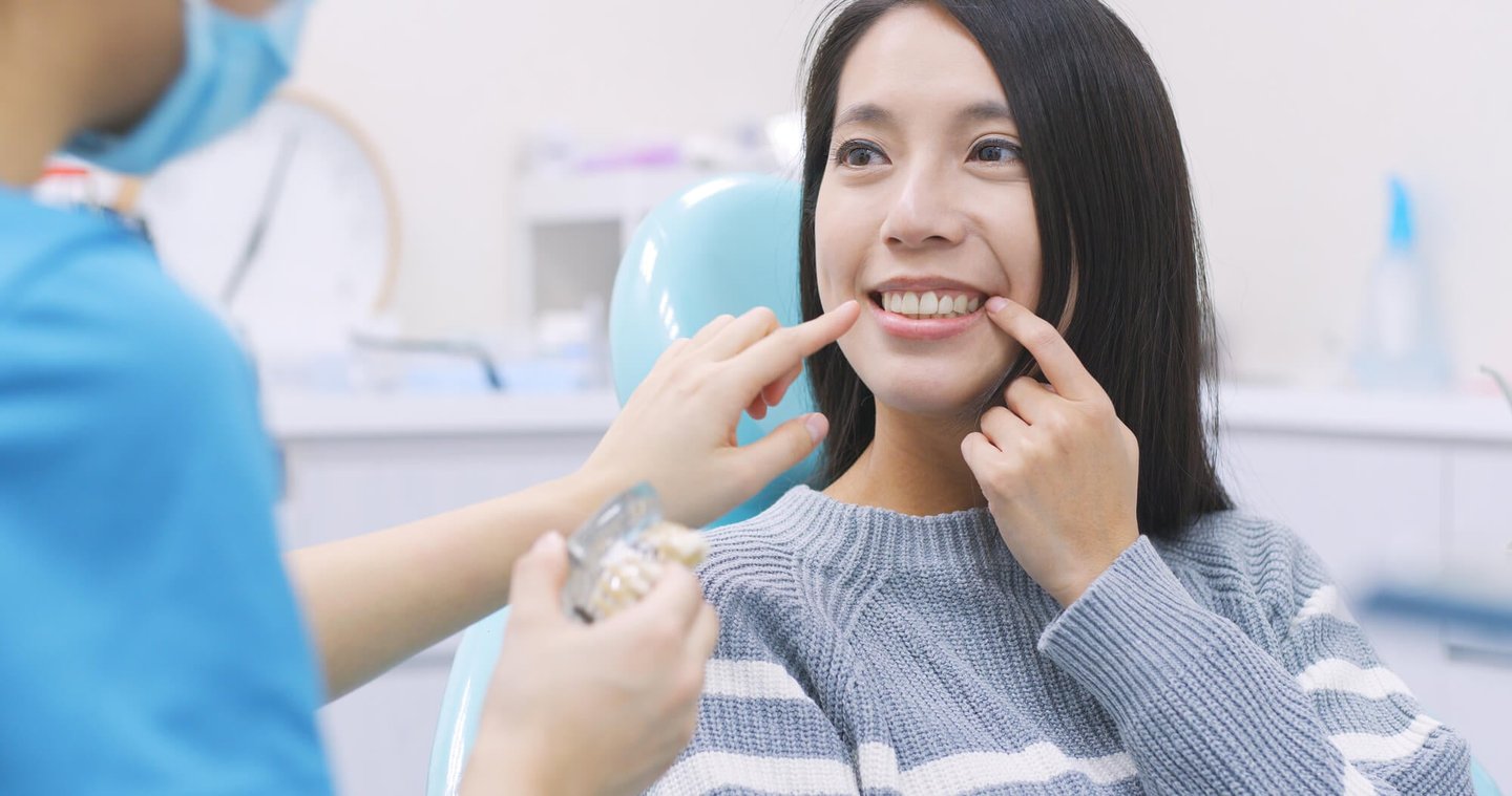 woman discussing dental implants with her dentist in winter park fl