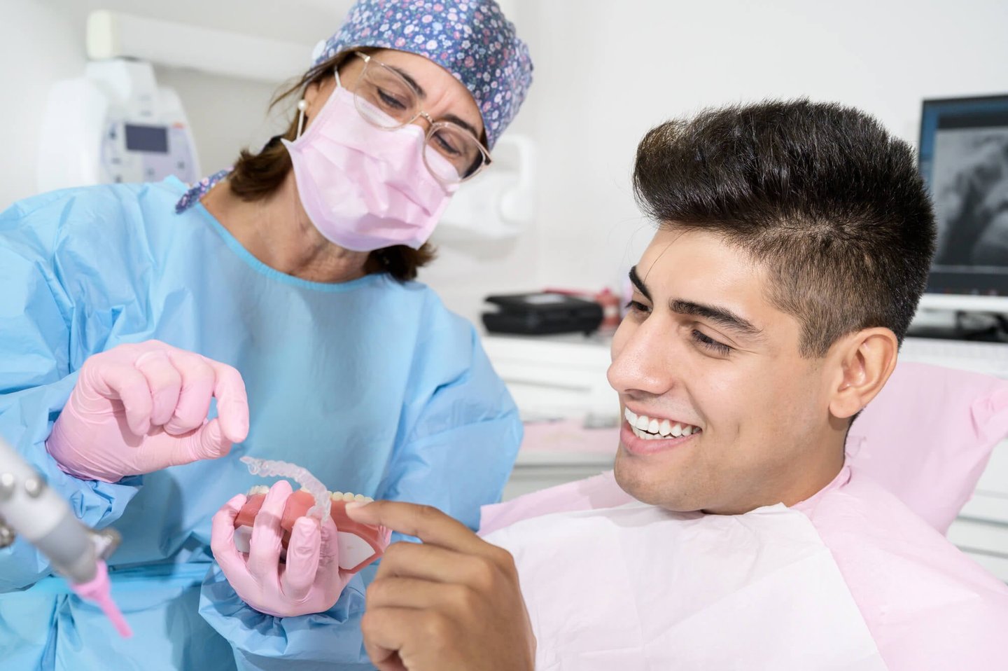 orthodontist showing patient his new winter park fl invisalign