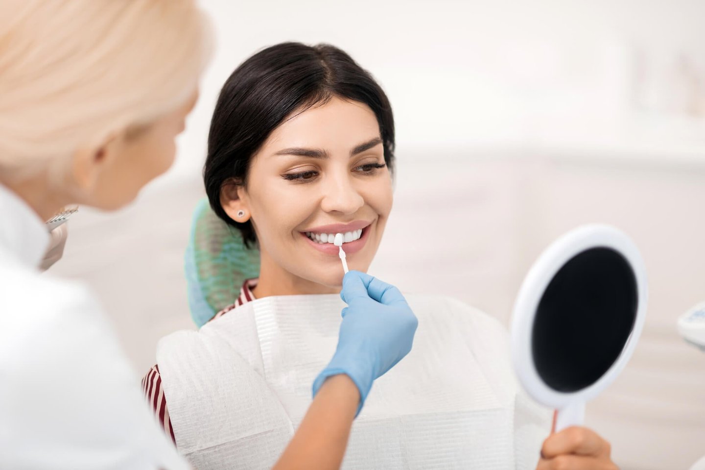 woman choosing a shade for her best veneers in orlando