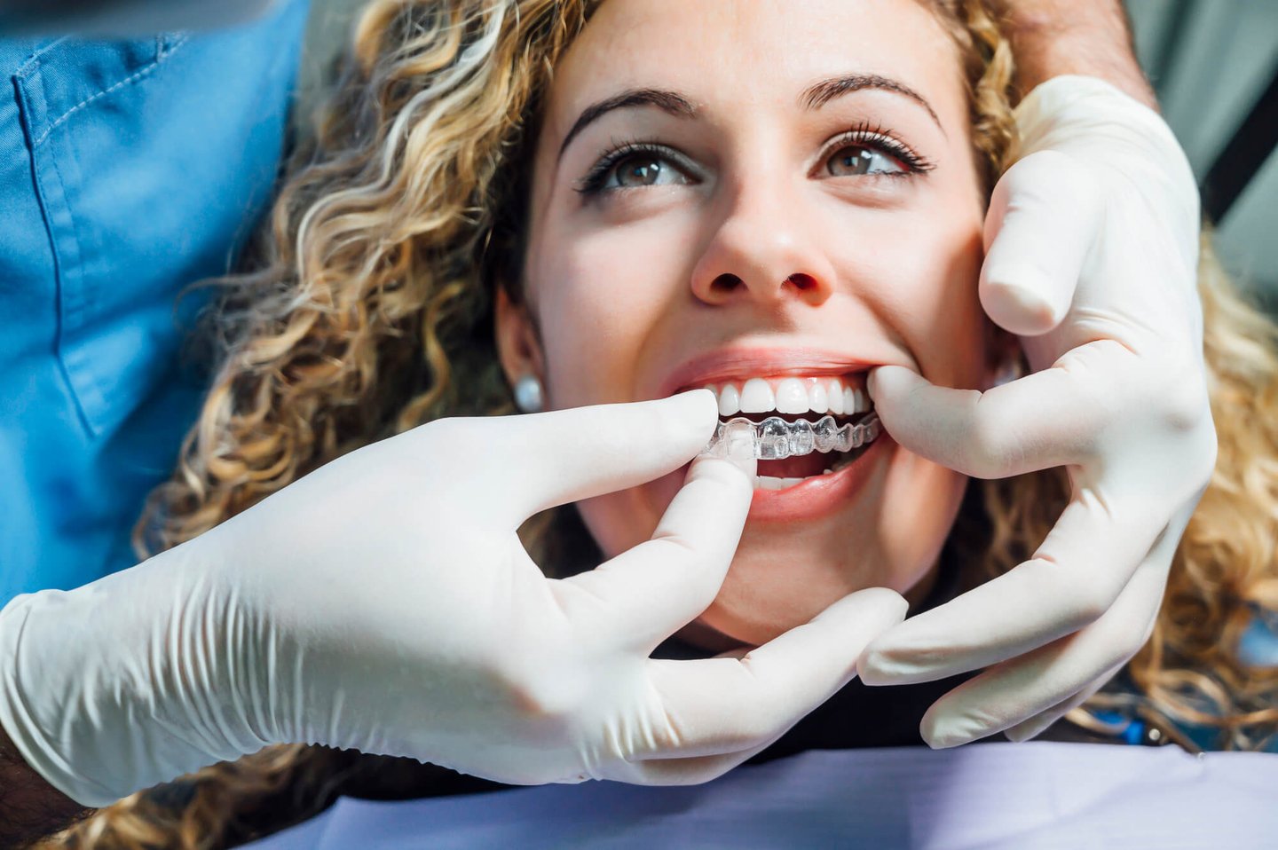 dentist assists client to put Winter Park, FL Invisalign