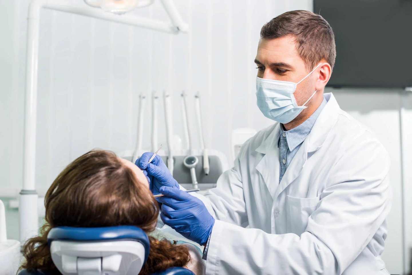 Dentist examining patient in dental chair dentist in Winter Park