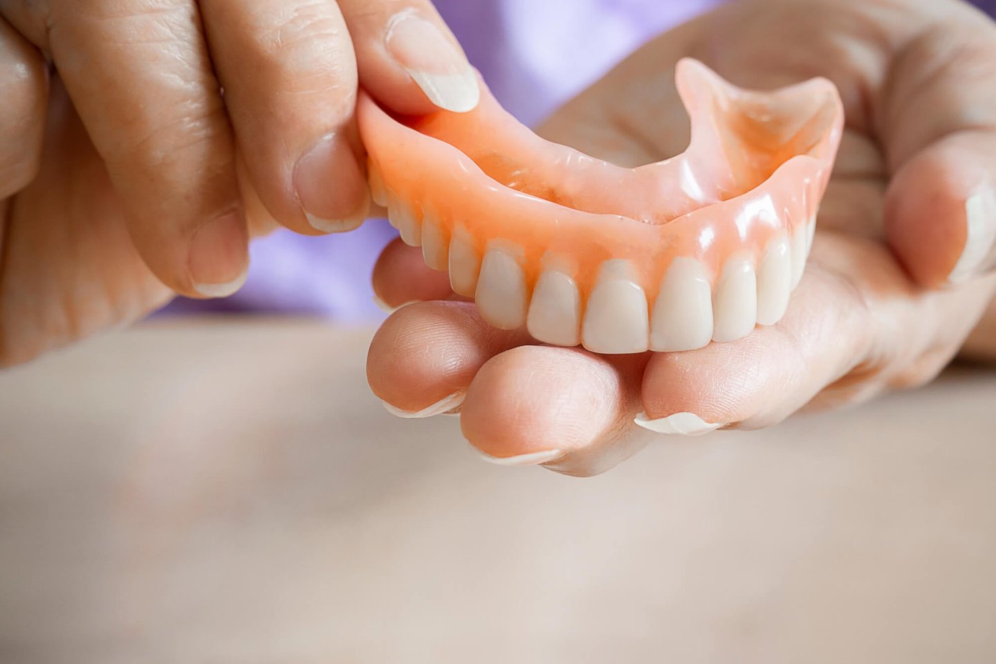 dentists in winter park fl holding dentures