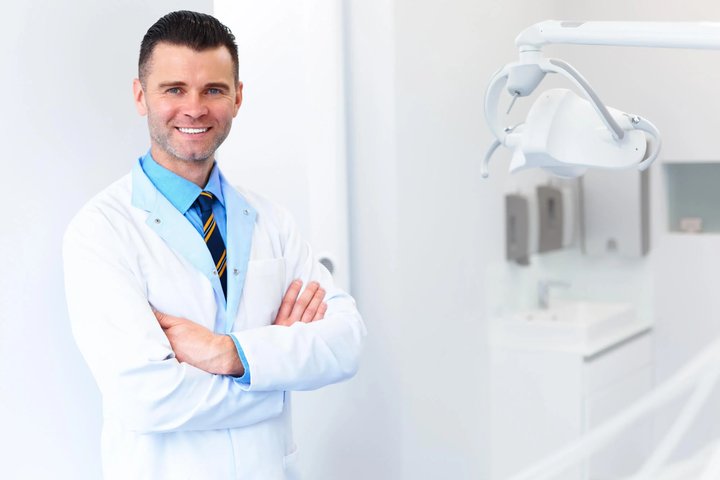 Confident dentist standing in modern clinic dentist in Winter Park