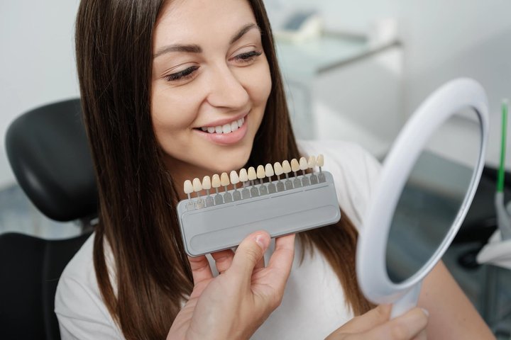 woman choosing a shade for her veneers winter park