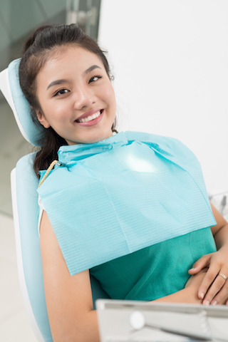 patient smiling in dentist chair before oral surgery in winter park, fl
